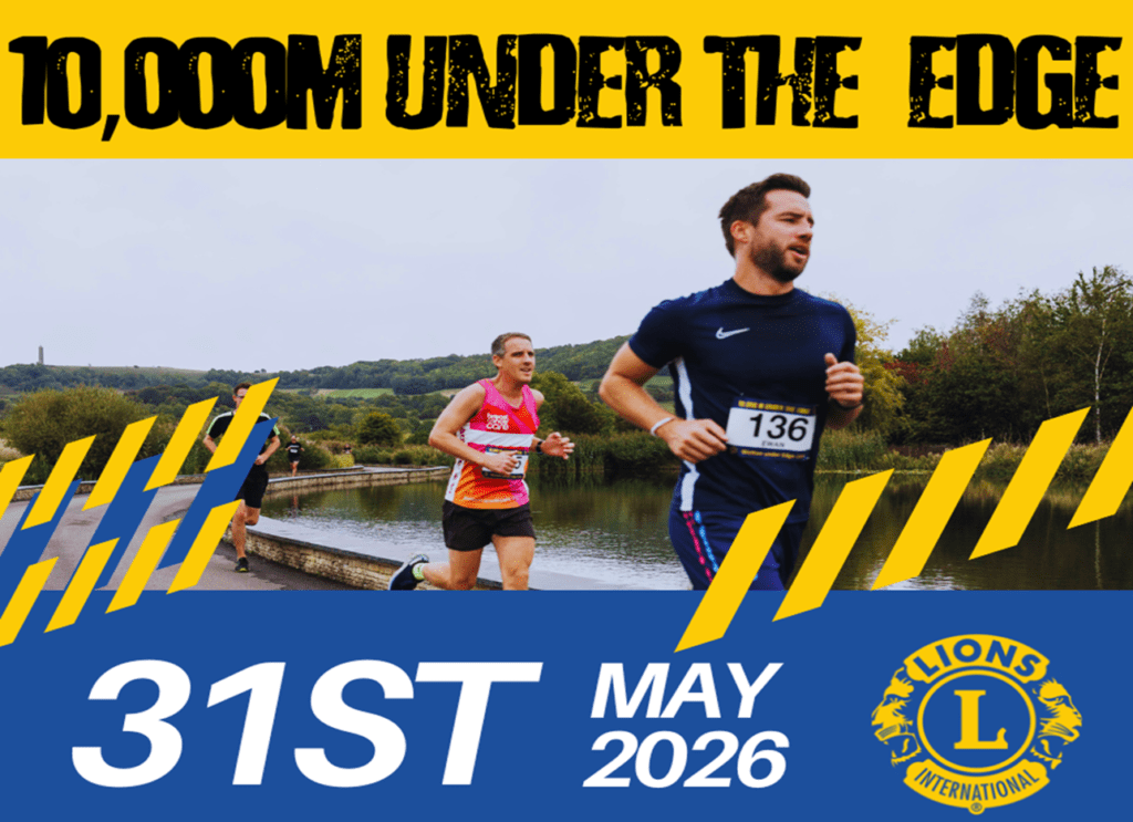 Poster depicting runners running past a lake with the Cotswold hills in the far background. Text reads, " 10,000M UNDER THE EDGE 31ST MAY 2026. Lions International." more details about the event below the poster